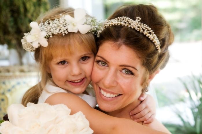 Toni Rigdon client — glowing bride with flower girl, both wearing floral headpieces