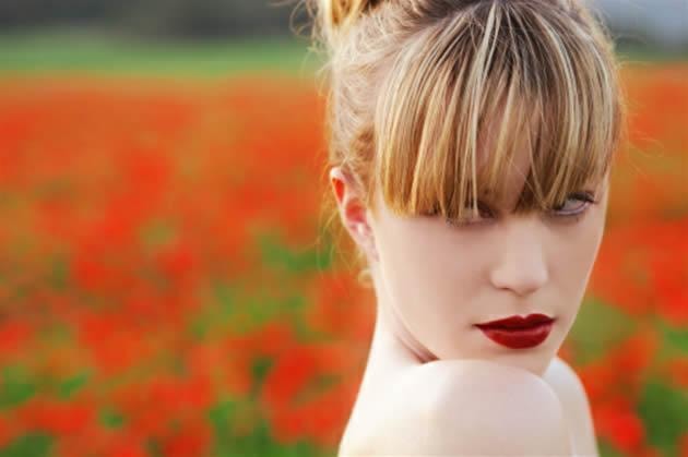 Beautiful woman with flawless makeup in a Napa Valley vineyard setting